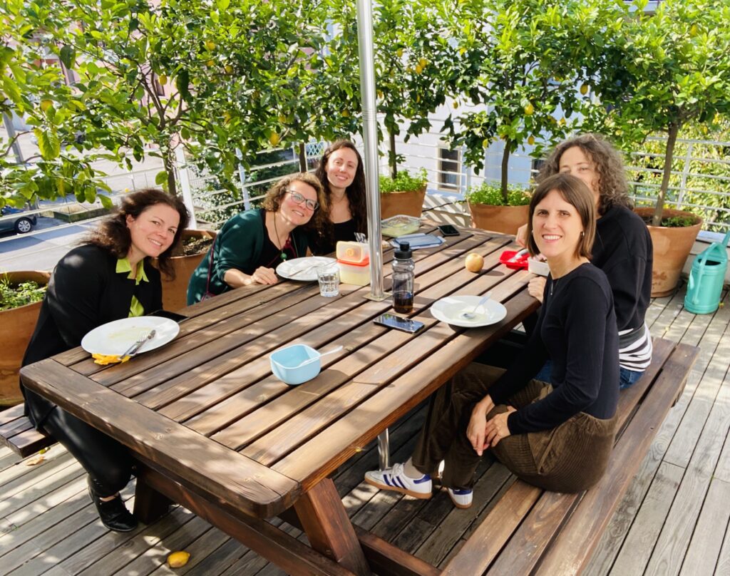 Team meeting and lunch outdoors at Girolibero headquarters terrace in Vicenza.